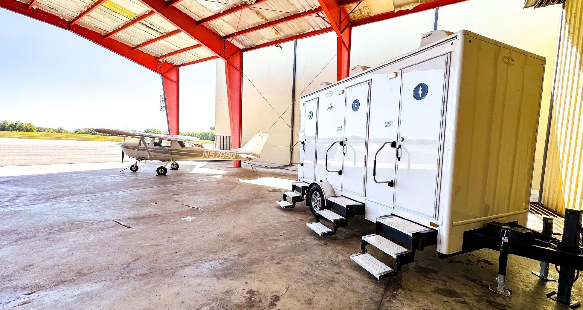 Portable restroom trailer in aviation hanger