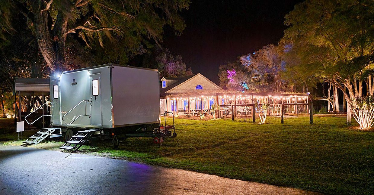 Portable Restroom Trailer At Nighttime Gathering